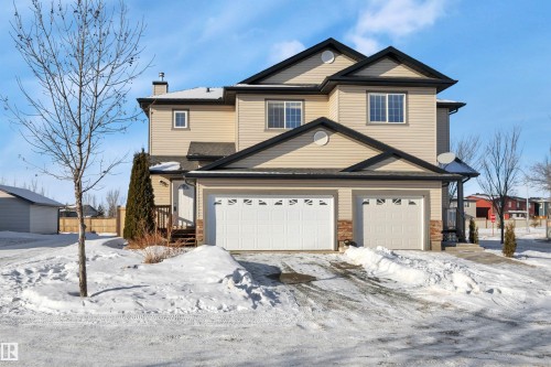 Traditional home with a chimney and an attached garage - 457 Aster Close, Leduc, AB - Outdoor With Facade