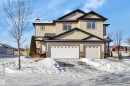 Traditional home with a chimney and an attached garage - 457 Aster Close, Leduc, AB  - Outdoor With Facade 