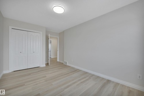 Unfurnished bedroom with light wood-type flooring and a closet - 457 Aster Close, Leduc, AB - Indoor Photo Showing Other Room
