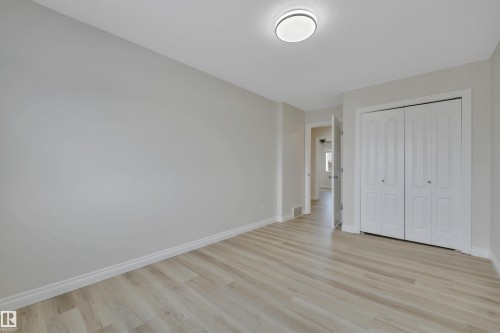 Unfurnished bedroom with light wood-style floors and a closet - 457 Aster Close, Leduc, AB - Indoor Photo Showing Other Room
