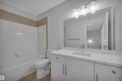Bathroom featuring vanity, bathing tub / shower combination, and light tile patterned floors - 