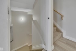 Stairway featuring baseboards and wood finished floors - 