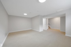 Finished below grade area with light colored carpet and stairway - 