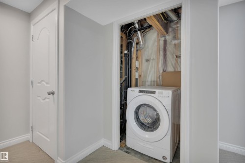 Washroom with washer / dryer and carpet floors - 457 Aster Close, Leduc, AB - Indoor Photo Showing Laundry Room