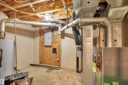 Utilities featuring water heater, heating unit, and electric panel - 