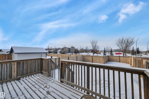 Wooden terrace featuring a fenced backyard and a residential view - 457 Aster Close, Leduc, AB - Outdoor With Deck Patio Veranda