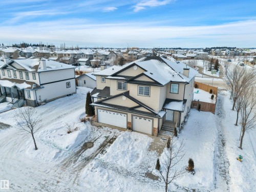 Snowy aerial view featuring a residential view - 457 Aster Close, Leduc, AB - Outdoor With Facade
