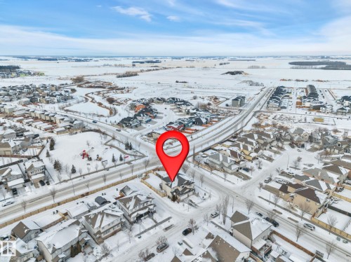 Snowy aerial view featuring a residential view - 457 Aster Close, Leduc, AB - Outdoor With View