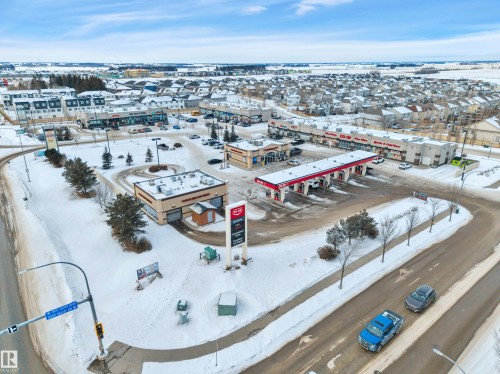 Snowy aerial view featuring view of commercial area - 457 Aster Close, Leduc, AB - Outdoor With View