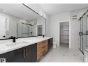Bathroom featuring a walk in closet, double vanity, a marble finish shower, and light marble finish floors - 138 South Ravines Drive, Devon, AB  - Indoor Photo Showing Bathroom 