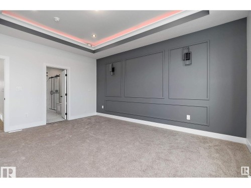 Unfurnished room with a raised ceiling and light colored carpet - 138 South Ravines Drive, Devon, AB - Indoor Photo Showing Other Room
