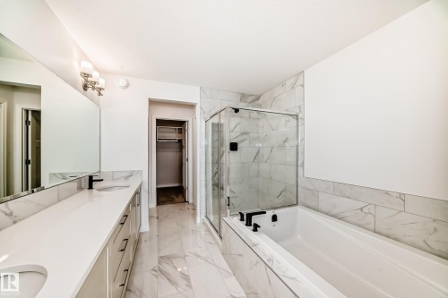 Full bath featuring a spacious closet, a marble finish shower, double vanity, a garden tub, and light marble finish floors - 3249 Dixon Way, Edmonton, AB - Indoor Photo Showing Bathroom