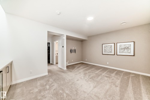 Spare room featuring light carpet and baseboards - 3249 Dixon Way, Edmonton, AB - Indoor Photo Showing Other Room