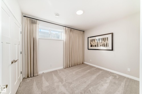 Unfurnished bedroom with light carpet and baseboards - 3249 Dixon Way, Edmonton, AB - Indoor Photo Showing Other Room
