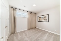 Unfurnished bedroom with light carpet and baseboards - 