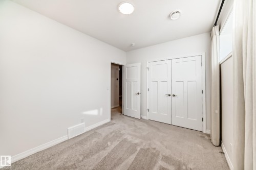 Unfurnished bedroom with carpet floors and a closet - 3249 Dixon Way, Edmonton, AB - Indoor Photo Showing Other Room