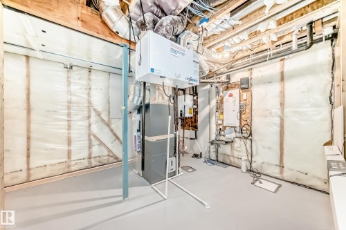 Unfinished below grade area featuring water heater - 3249 Dixon Way, Edmonton, AB - Indoor Photo Showing Basement