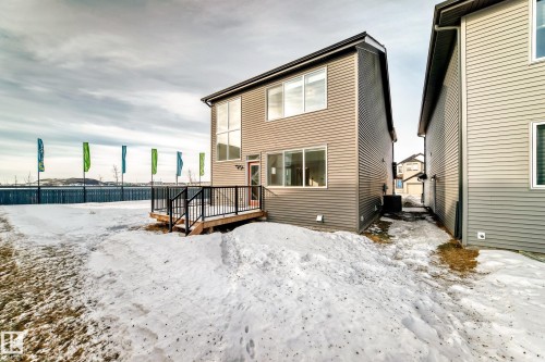 Snow covered house featuring a deck - 3249 Dixon Way, Edmonton, AB - Outdoor With Exterior