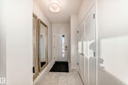 Entryway featuring baseboards and light marble finish floors - 