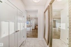 Corridor with a chandelier and light marble finish floors - 
