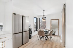 Dining area with light wood-style flooring and a chandelier - 