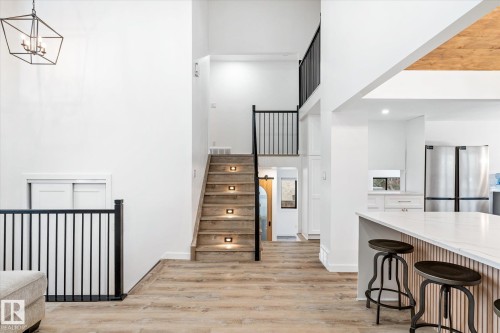 Stairway with wood finished floors, a high ceiling, and recessed lighting - 38 Woodcrest Avenue, St. Albert, AB - Indoor