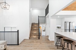 Stairway with wood finished floors, a high ceiling, and recessed lighting - 