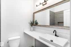 Bathroom with vanity, tiled shower, tasteful backsplash, and a tiled fireplace - 