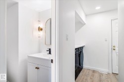 Bathroom with vanity, light wood-style floors, independent washer and dryer, and recessed lighting - 