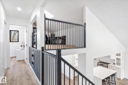 Hall with light wood-style flooring and baseboards - 