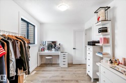 Walk in closet with light wood-style floors - 