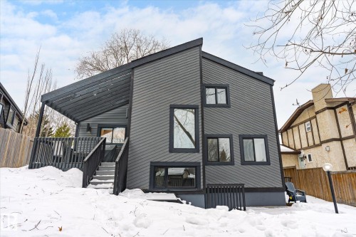 Snow covered property featuring a wooden deck and stairs - 38 Woodcrest Avenue, St. Albert, AB - Outdoor