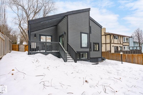 Snow covered property featuring a fenced backyard and a wooden deck - 38 Woodcrest Avenue, St. Albert, AB - Outdoor