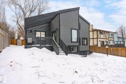 Snow covered property featuring a fenced backyard and a wooden deck - 