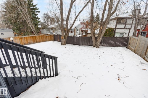 Snowy yard featuring a residential view, a fenced backyard, and a deck - 38 Woodcrest Avenue, St. Albert, AB - Outdoor