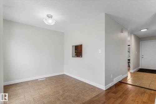 Entryway featuring light tile patterned flooring and a textured ceiling - 289 Grandin Village, St. Albert, AB - Indoor Photo Showing Other Room