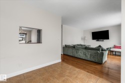 Tiled living room featuring baseboards - 