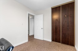 Unfurnished bedroom featuring carpet floors, a closet, and a textured ceiling - 