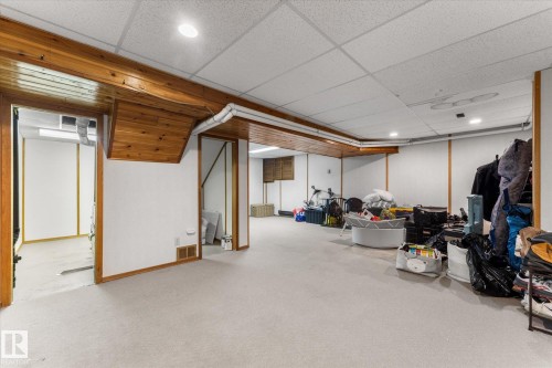 Finished below grade area featuring a paneled ceiling and carpet flooring - 289 Grandin Village, St. Albert, AB - Indoor