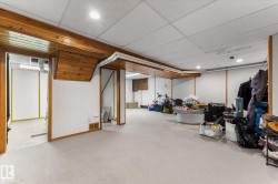 Finished below grade area featuring a paneled ceiling and carpet flooring - 