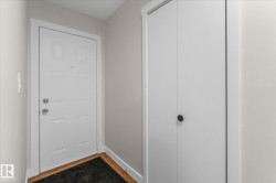 Doorway featuring wood finished floors and baseboards - 