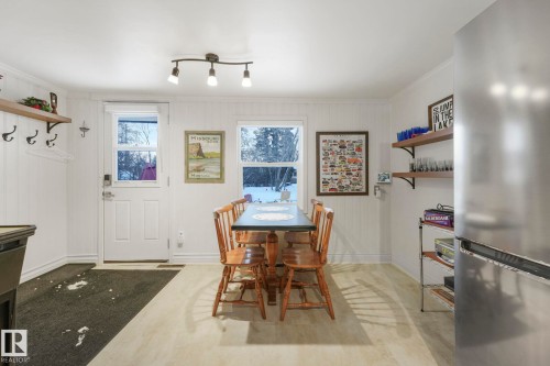 Dining space featuring baseboards and wood walls - 5043 48 St, Sylvan Lake, AB - Indoor