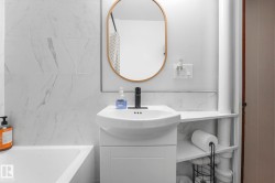 Full bath featuring vanity, tile walls, and bathtub / shower combination - 