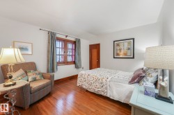 Bedroom featuring wood finished floors and baseboards - 