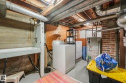 Unfinished basement with washer and dryer and gas water heater - 