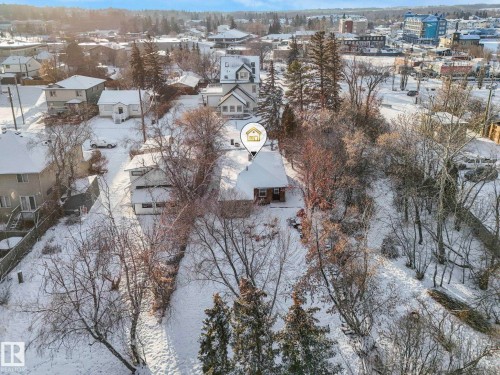 Snowy aerial view featuring a residential view - 5043 48 St, Sylvan Lake, AB - Outdoor With View