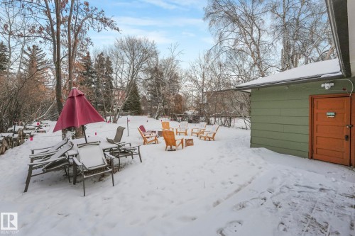 Yard layered in snow with view of wooded area - 5043 48 St, Sylvan Lake, AB - Outdoor