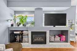 Detailed view of a tile fireplace and wood finished floors - 