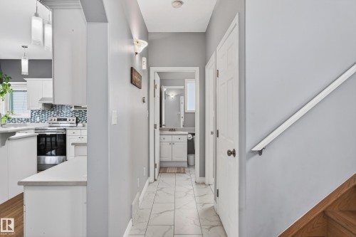 Corridor with baseboards and light marble finish flooring - 24 Olmstead Court, St. Albert, AB - Indoor Photo Showing Other Room
