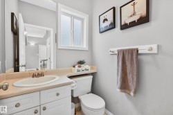Half bathroom featuring vanity and toilet - 